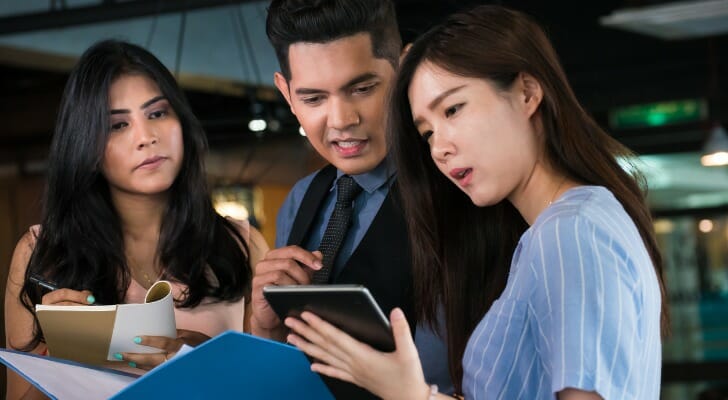 A team of client service associates in a discussion