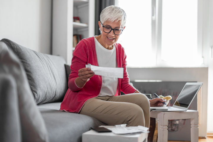 A senior creating a retirement budget to save money.