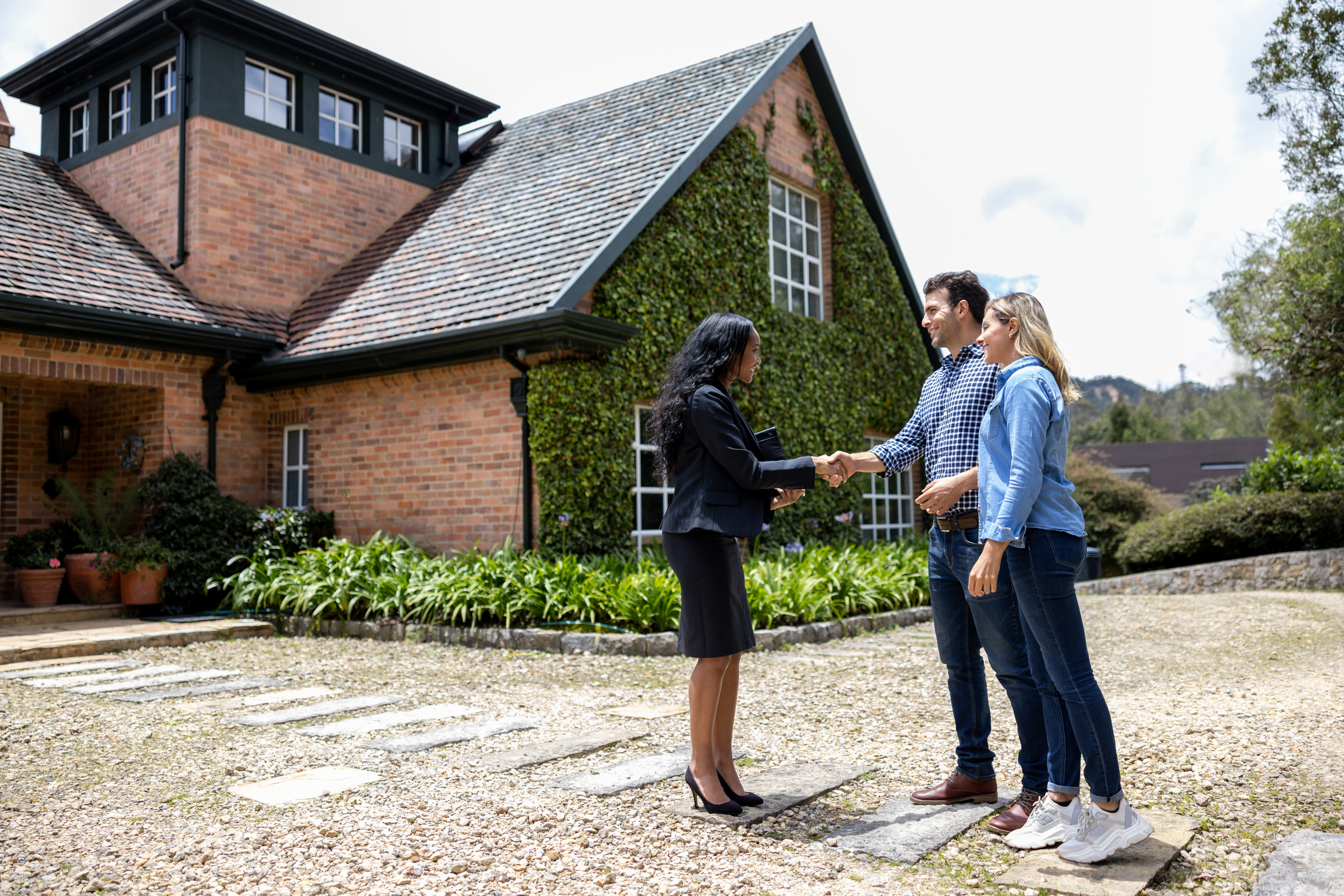 A real estate agent meeting potential tenants for a house.