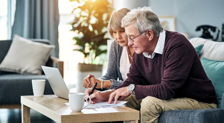 A senior couple designating a beneficiary for their retirement accounts.