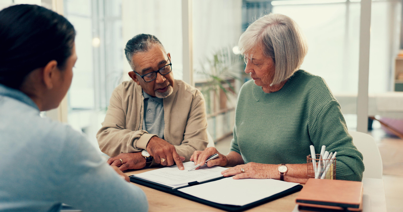 A couple sits down to discuss estate planning with their advisor.